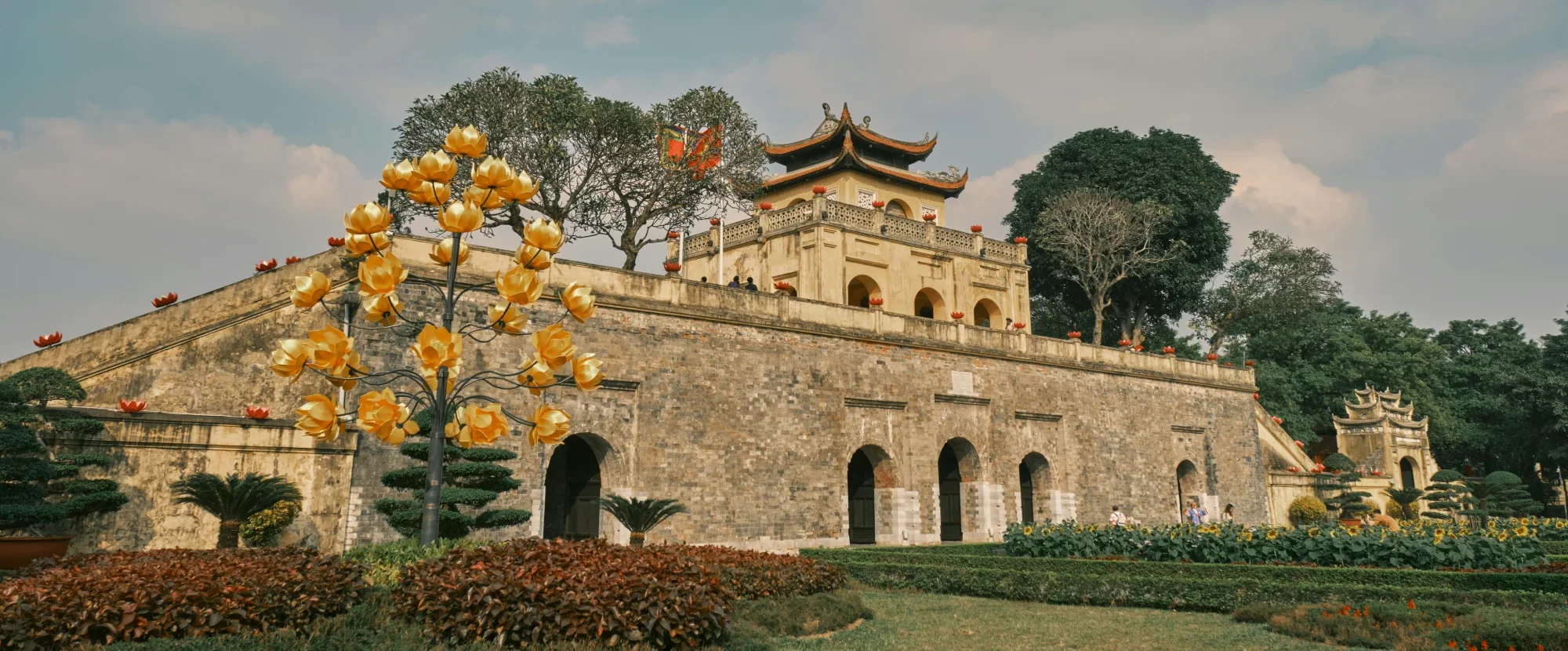 Wide angled view of the stone Hanoi citadel surrounded by well-tended gardens