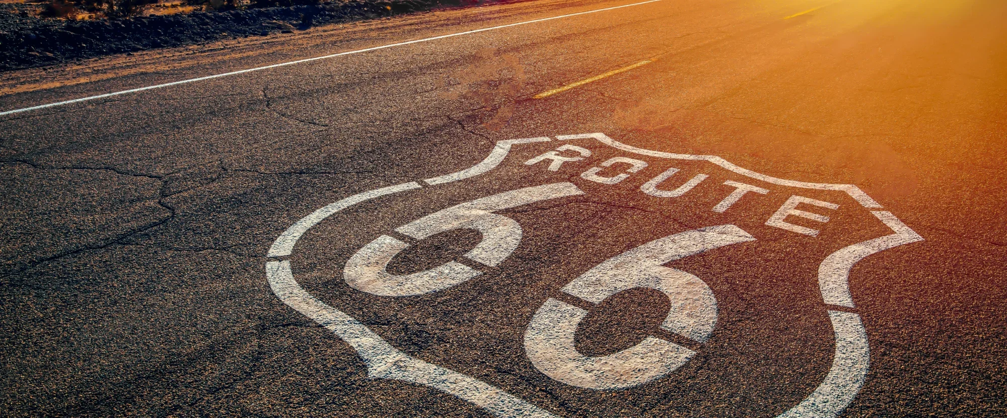 White Route 66 logo stencilled on a highway in the USA