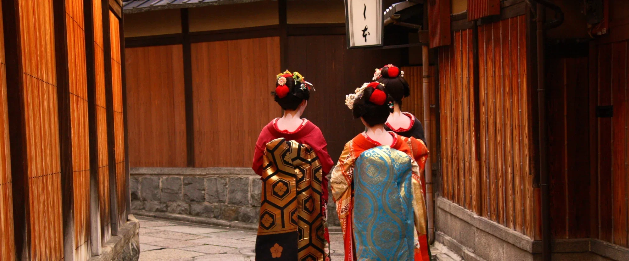 Geishas walking through the streets of Kyoto, Japan